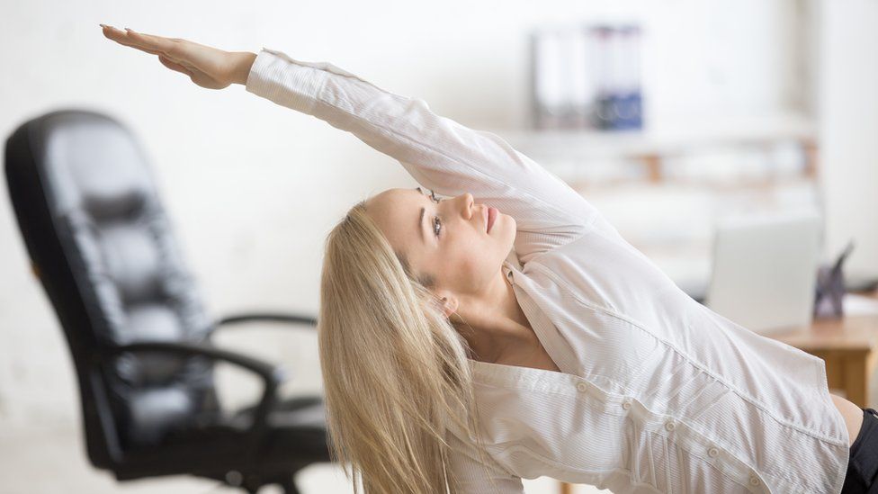 Woman doing pilates in the office