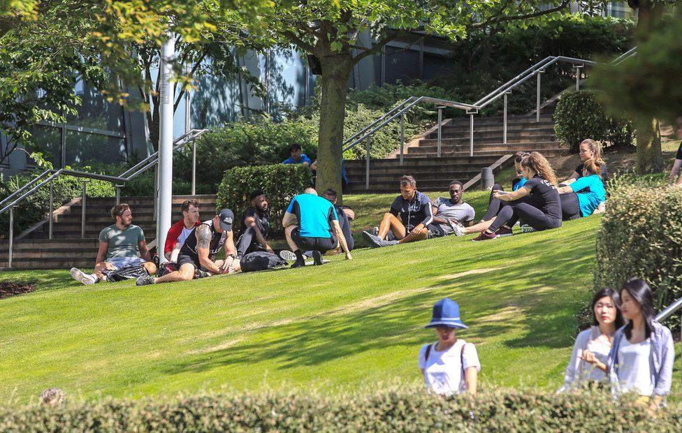 People enjoy the sunshine at Chavasse Park in Liverpool