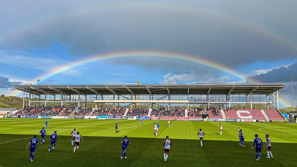 The half built East Stand at Northampton Town with a rainbow in the sky