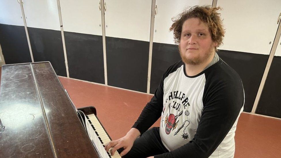Service user playing piano at the drop in centre