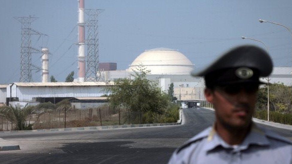 An Iranian security guard standing in front of the Bushehr nuclear power plant (2010)