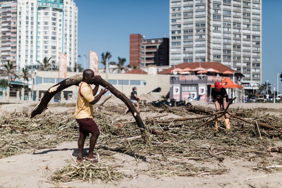 Volunteers and members of the public clean up on North Beach following heavy rains earlier in the week in Durban.
