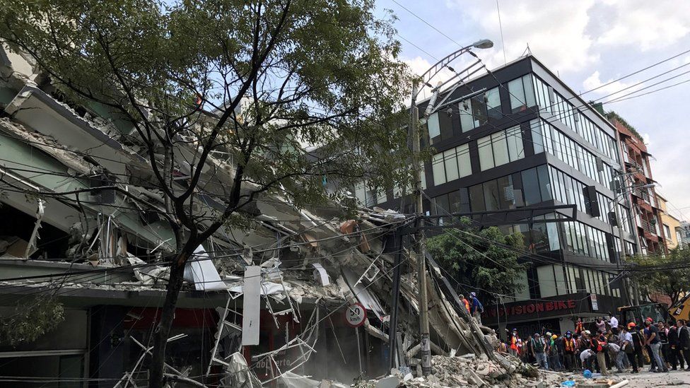 collapsed building next to another of glass and metal in Mexico City