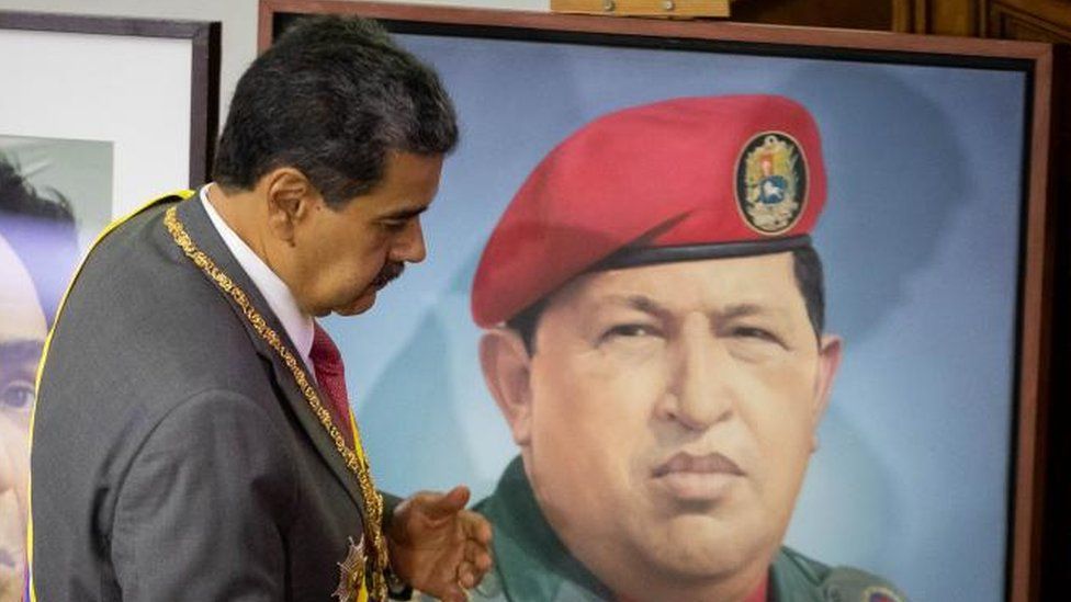 Venezuelan president, Nicolas Maduro passes by two paintings with portraits of Simon Bolivar and the late president Hugo Chavez (R), as he presents his accountability before the National Assembly (AN, Parliament), in Caracas, Venezuela, 15 January 2024.