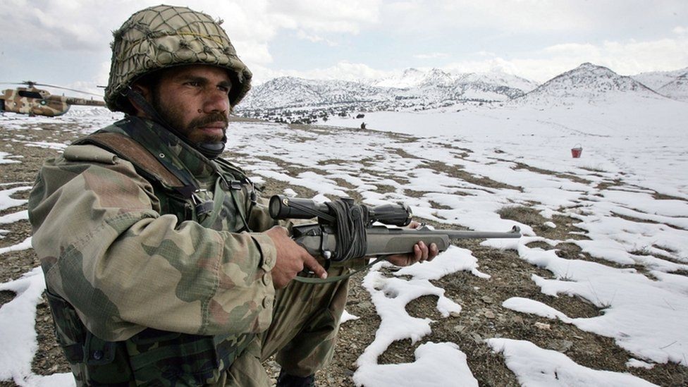 A Pakistani soldier stands guard on the Pakistan-Afghan border