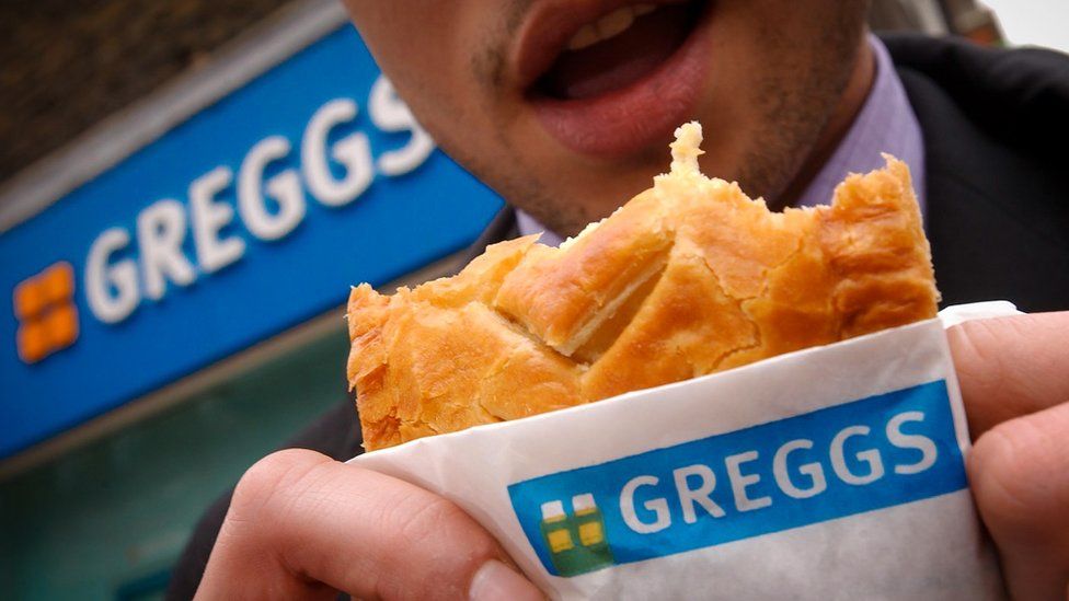 Man eating Greggs pasty