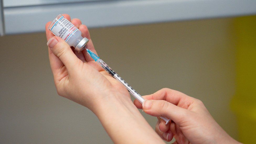A Moderna vaccine dose being prepared