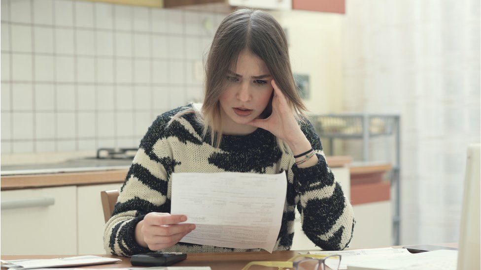 Woman looking at bills