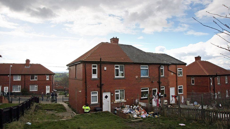 A police woman guards the empty family home of Shannon Matthews on April 7, 2008, Dewsbury, England