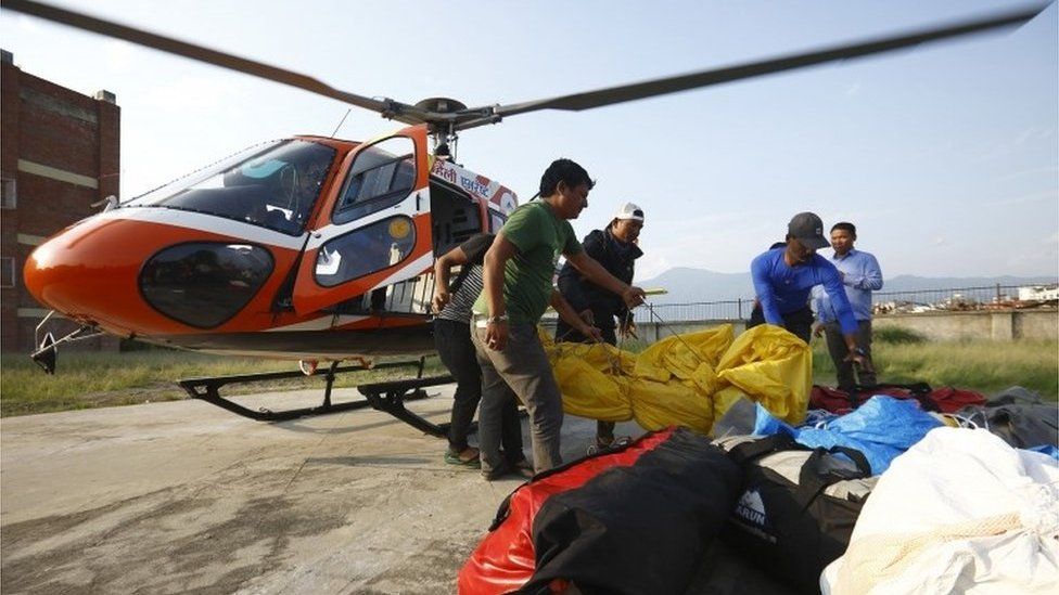 Officials carry the bodies of Indian climbers recovered from Mount Everest and airlifted to Teaching Hospital in Kathmandu on May 28, 2017.