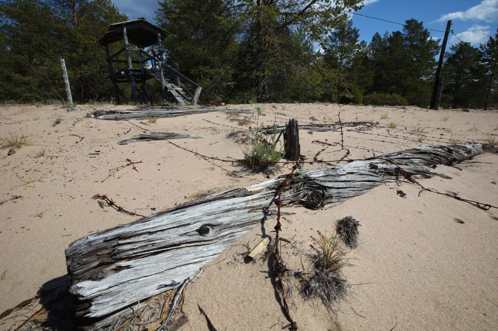 A dilapidated watchtower and barbed wire on Mudyug island