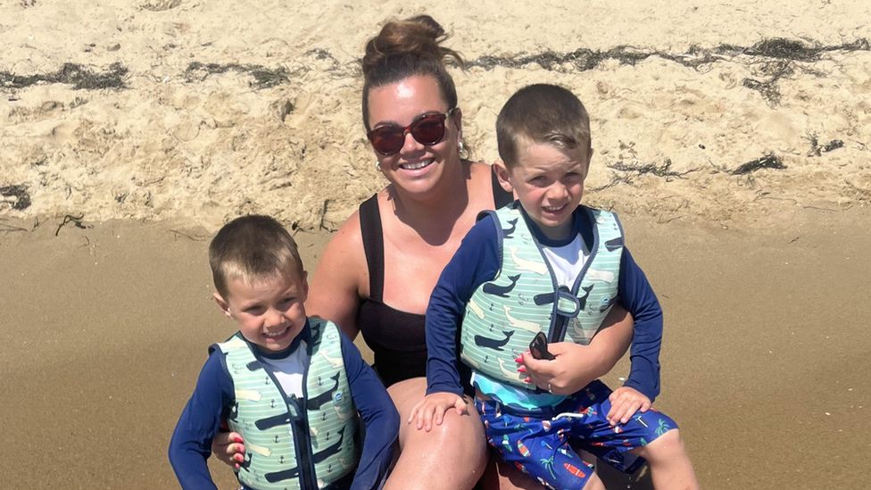 Jasmine Clarke on a beach with her twin boys