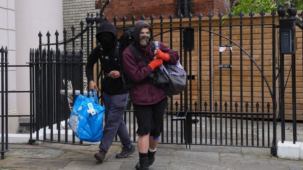 Two squatters leaving Gordon Ramsay's pub