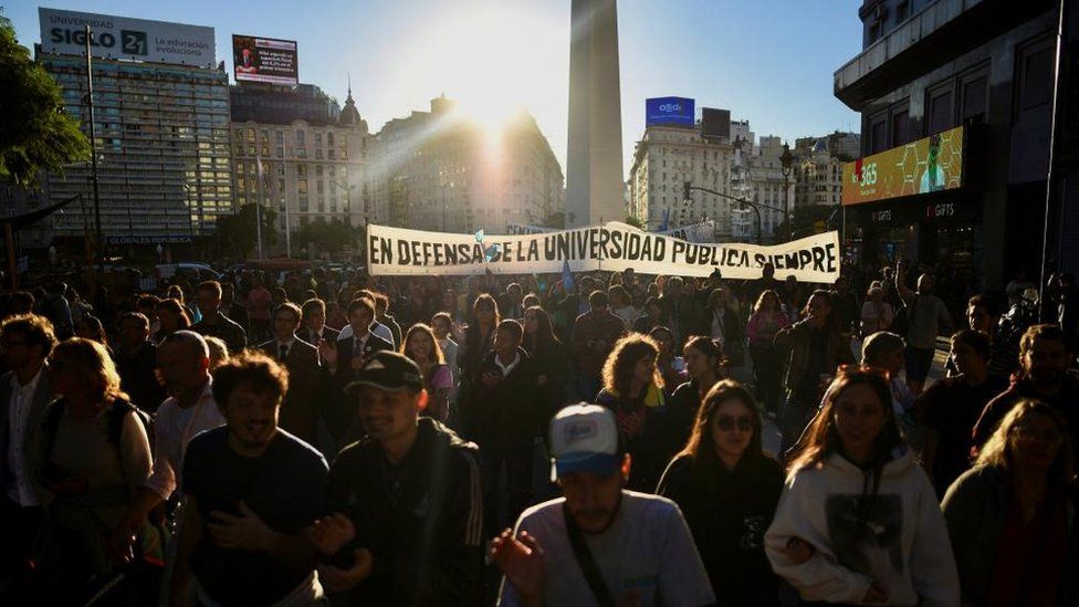 Argentina university students march against cuts to university spending. A banner reads: "In defence of the public university always."
