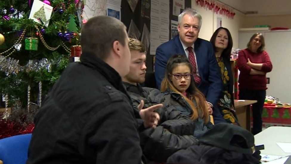 Carwyn Jones talks to young homeless people at the offices of Llamau in Cardiff