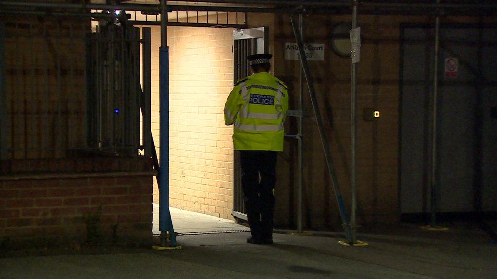 A police officer outside the building in Wood Green where the incident took place