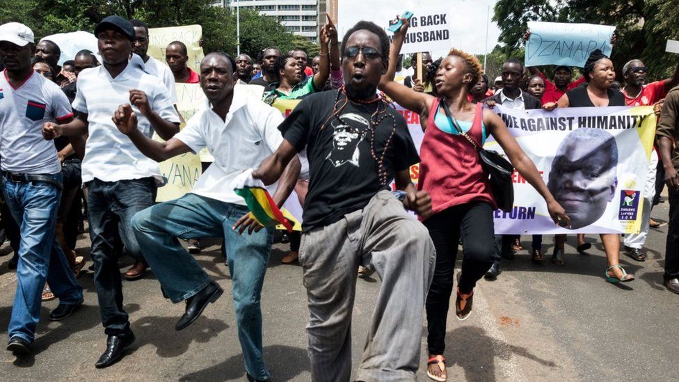 Demonstrators sing, dance and shout political slogans during a march to mark the one year anniversary of the disappearance of Itai Dzamara on March 9, 2016 in Harare. Dzamara a former journalist before he turned political activist was the leader of a group called Occupy Africa Unity Square park which sought to pressure Mugabe to step down for presiding over the collapse of the economy.