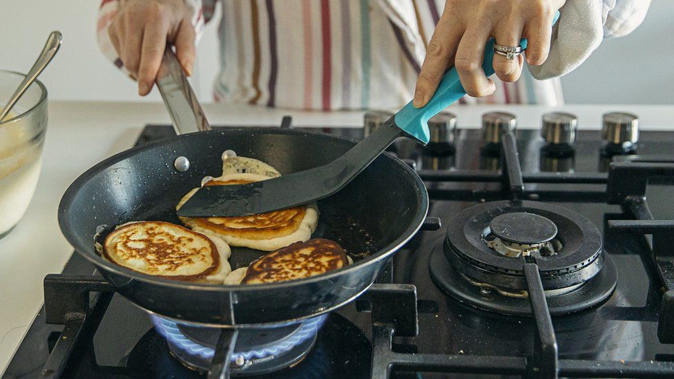 Woman cooking on hob