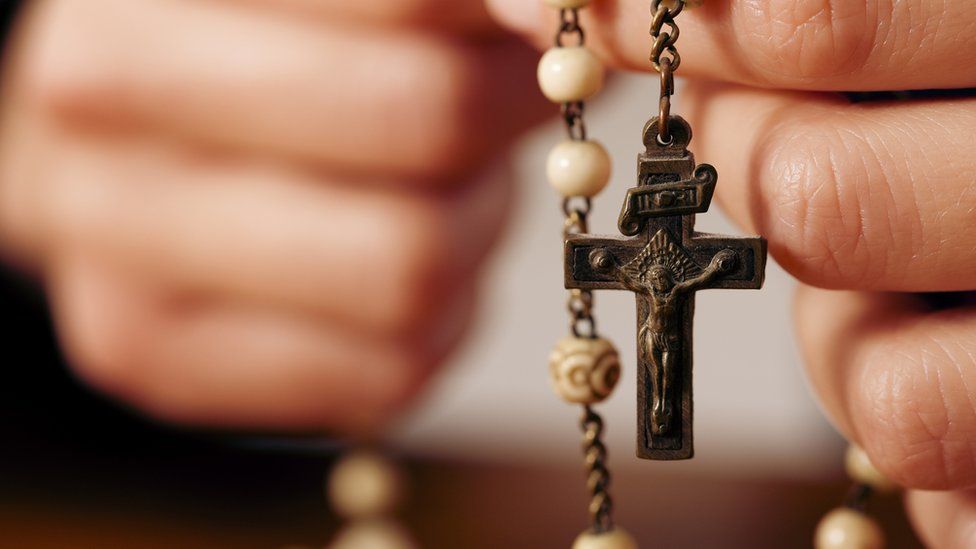 A person holds a rosary