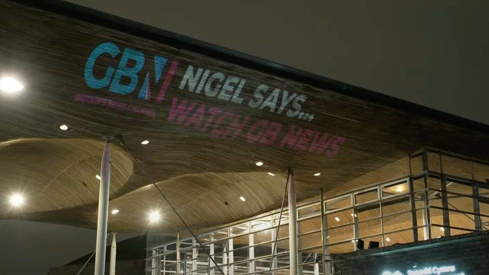 Projection of GB News logo on side of the Senedd
