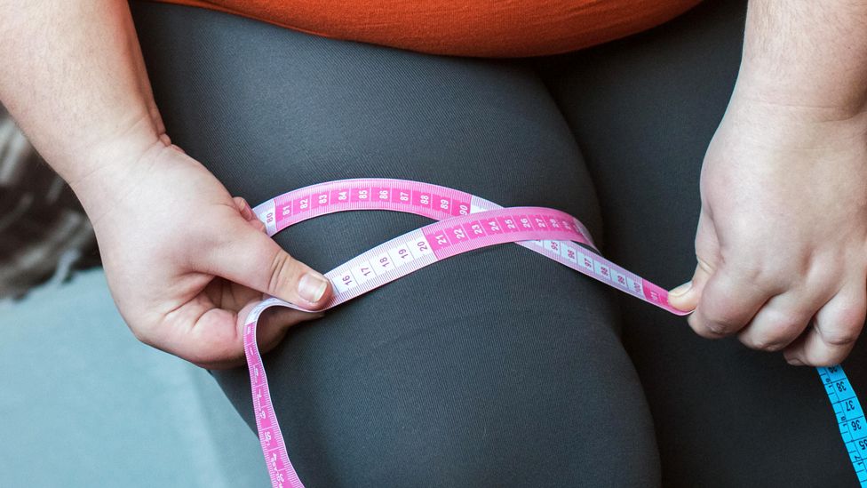 Overweight Woman With Tape Measure Around Waist. Woman Belly Fat