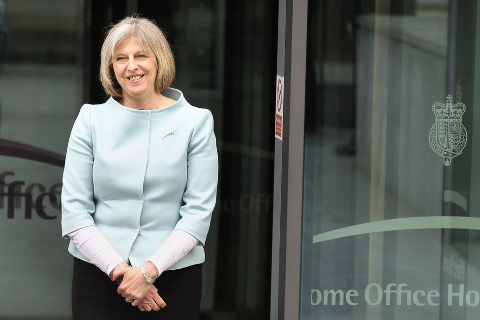 Theresa May stands at the Entrance to the Home Office in May 2010