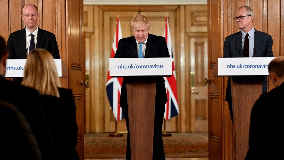 Chief Medical Officer Professor Chris Whitty (L) and Chief Scientific Adviser Patrick Vallance (R) look on as British Prime Minister Boris Johnson (C) speaks during a coronavirus news conference inside number 10 Downing Street on March 19, 2020 in London