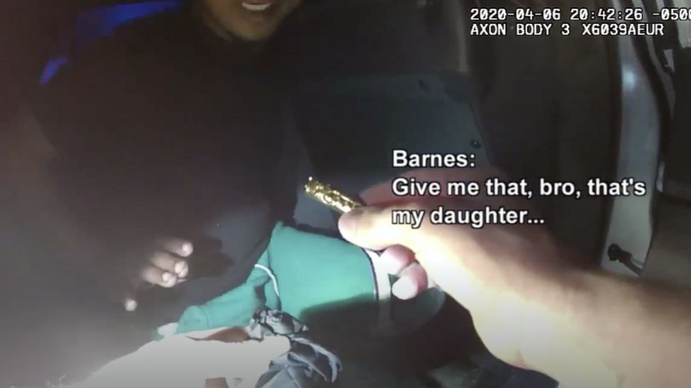 screenshot of the body camera footage showing the small urn in police hands