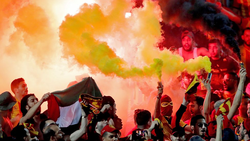 Esperance football fans holding flares at the al-Ahly Stadium in Cairo, Egypt - Friday 28 February 2020