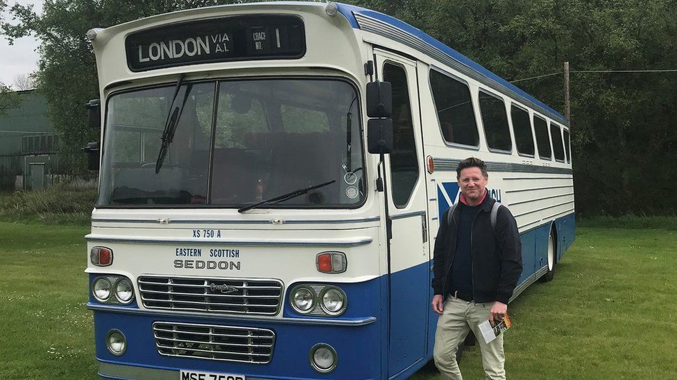 Tom Humphries with an old bus at a museum