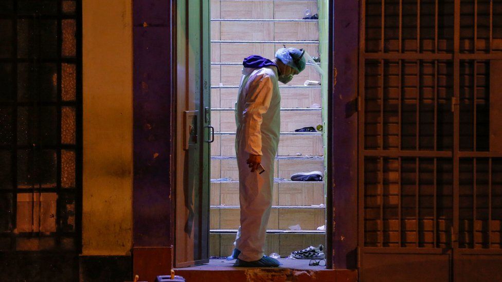 Police investigator stands on the site where 13 people were killed in a crush at a nightclub doorway on 22 August 2020