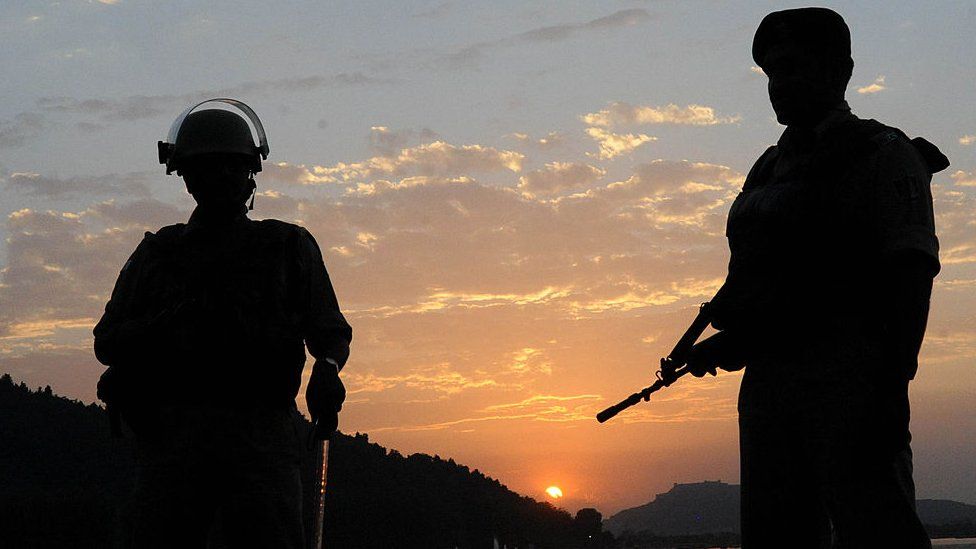 Indian paramilitary soldiers stand guard as the sun sets over Dal Lake in Srinagar on June 20, 2011.