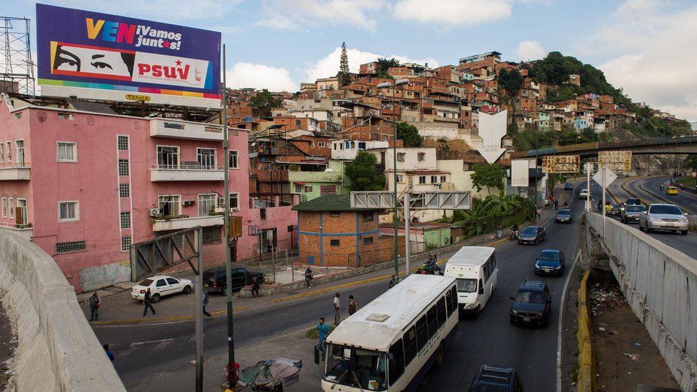 Billboard showing political slogans and depicting the eyes of late Venezuelan President Hugo Chavez, in Caracas