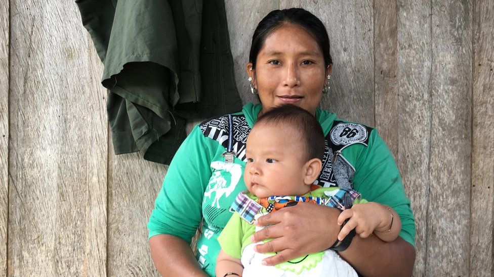 A female Farc member and her baby pose for the camera in Icononzo