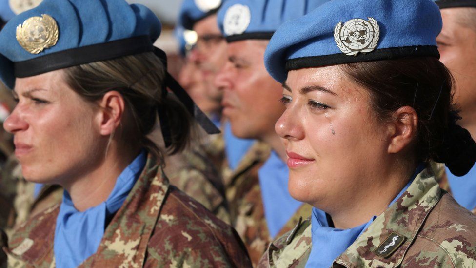 An Italian member of the UN Interim Force in Lebanon (UNIFIL) cries as the Italian Foreign Minister gives a speech during his visit to the Italian UNIFIL headquarters in the southern Lebanese village of Shamaa on May 18, 2017