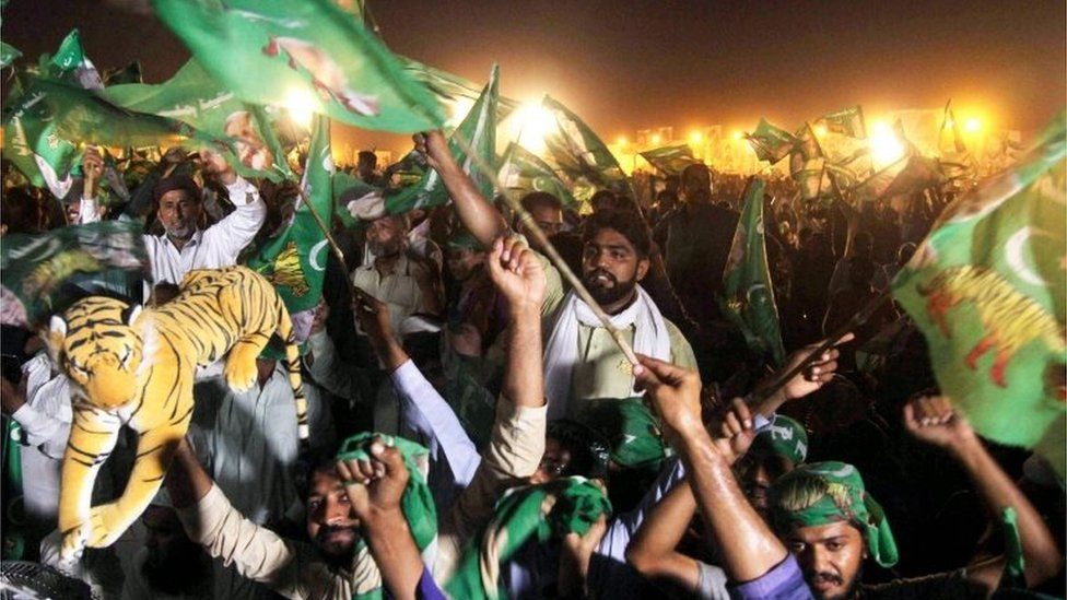 Pakistan Muslim League-Nawaz (PML-N), chant slogans and wave flags during a campaign meeting ahead of the general election in Multan on July 22, 2018.