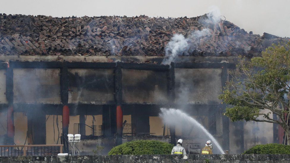 Firefighters try to extinguish a fire at Shuri Castle
