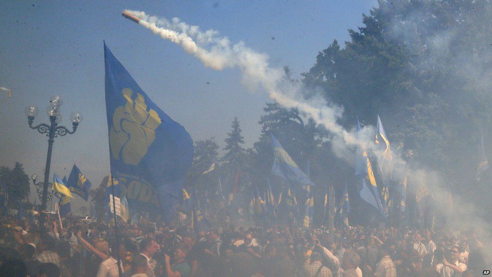 A smoke bomb is thrown outside parliament in Kiev