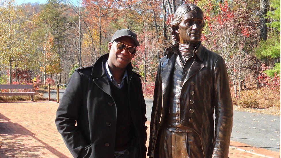 Roger Griffth standing next to a statue of Thomas Jefferson in Virginia