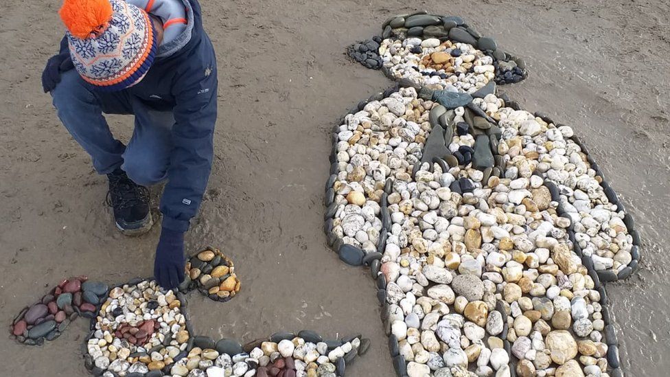 Beach art of the Snowman and Snowdog