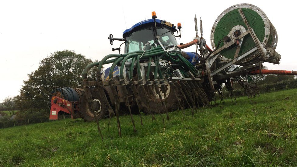 A tractor spreading slurry in County Antrim