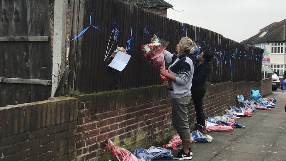 Friends and family of Henry Vincent tie tributes to a fence