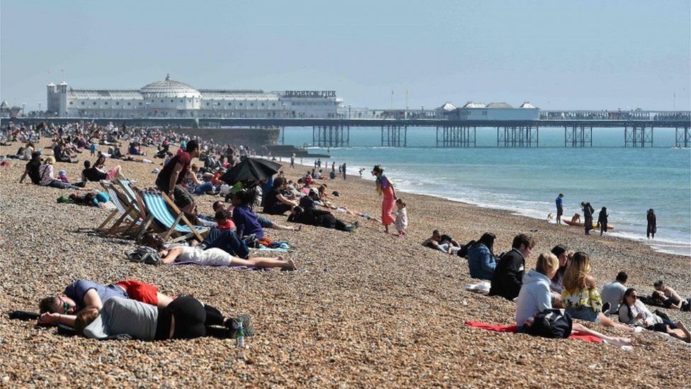 People lying on Brighton beach