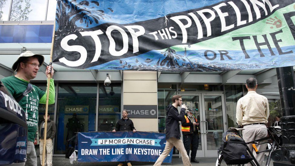 Activists disrupt business at a Chase Bank branch in Seattle on May 8, 2017