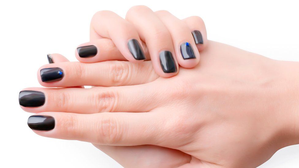 Black fingernails on a woman's hands