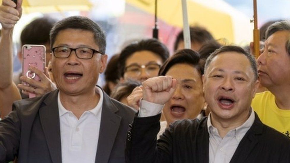 Activists Chan Kin-man, Benny Tai, and Chu Yiu-ming outside court in Hong Kong ahead of their sentencing, April 2019