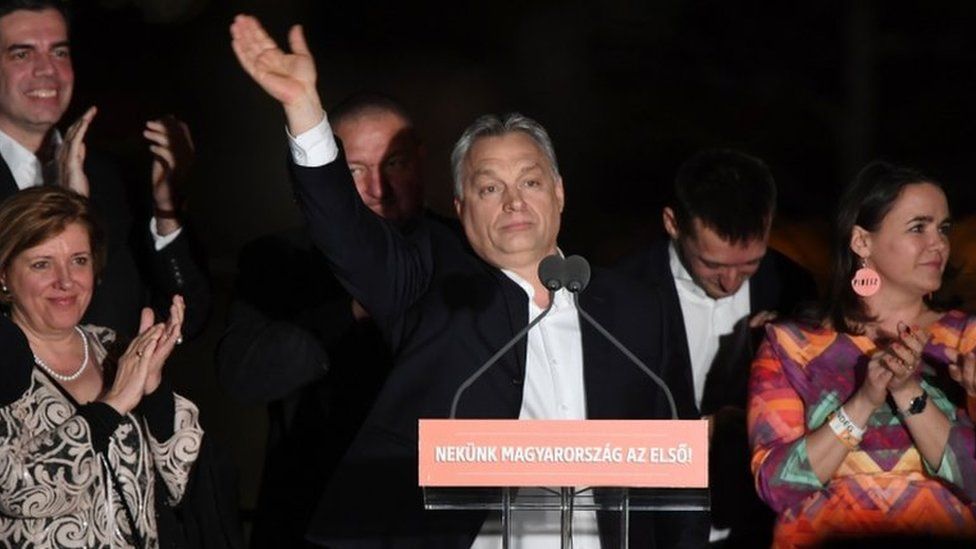 Hungarian Prime Minister Viktor Orban (C) and members of his FIDESZ party celebrate winning the election