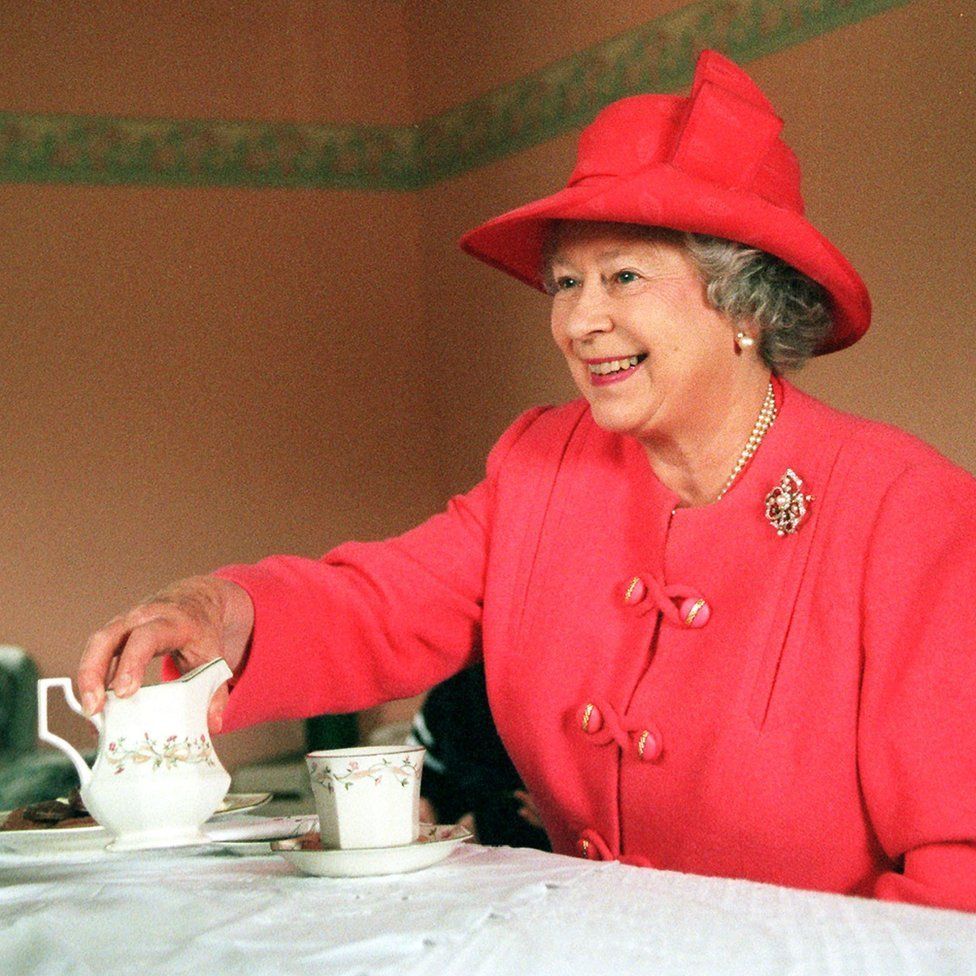 The Queen joining Mrs Susan McCarron for tea in her home in the Castlemilk area of Glasgow