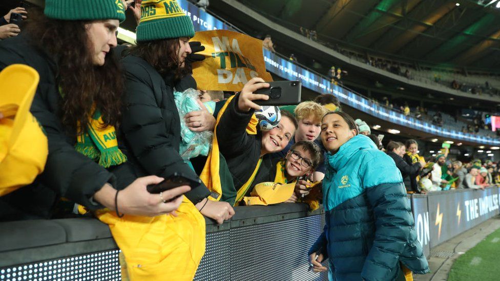Sam Kerr poses for a photos with fans