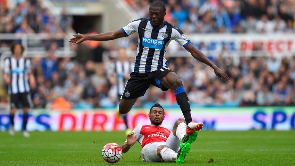 Chancel Mbemba of Newcastle United and Francis Coquelin of Arsenal compete for the ball during the Barclays Premier League match between Newcastle United and Arsenal at St James' Park on August 29, 2015 in Newcastle upon Tyne, England